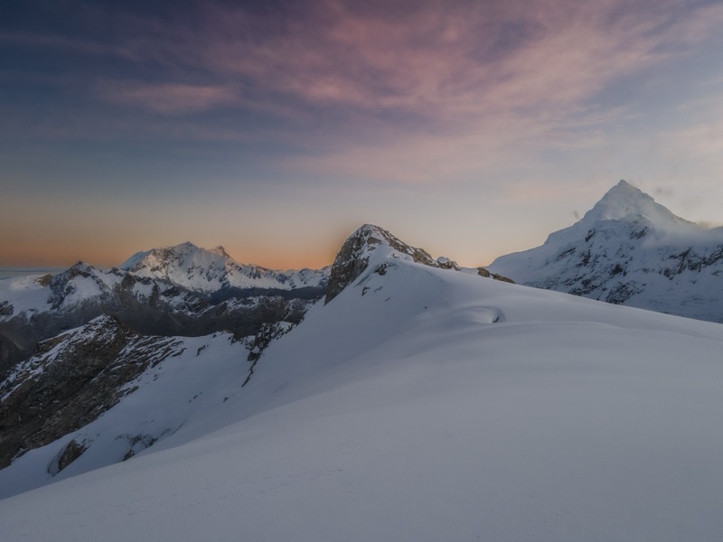 Alpenglow over snowbound peaks in Peru's Cordillera Blanca at dusk