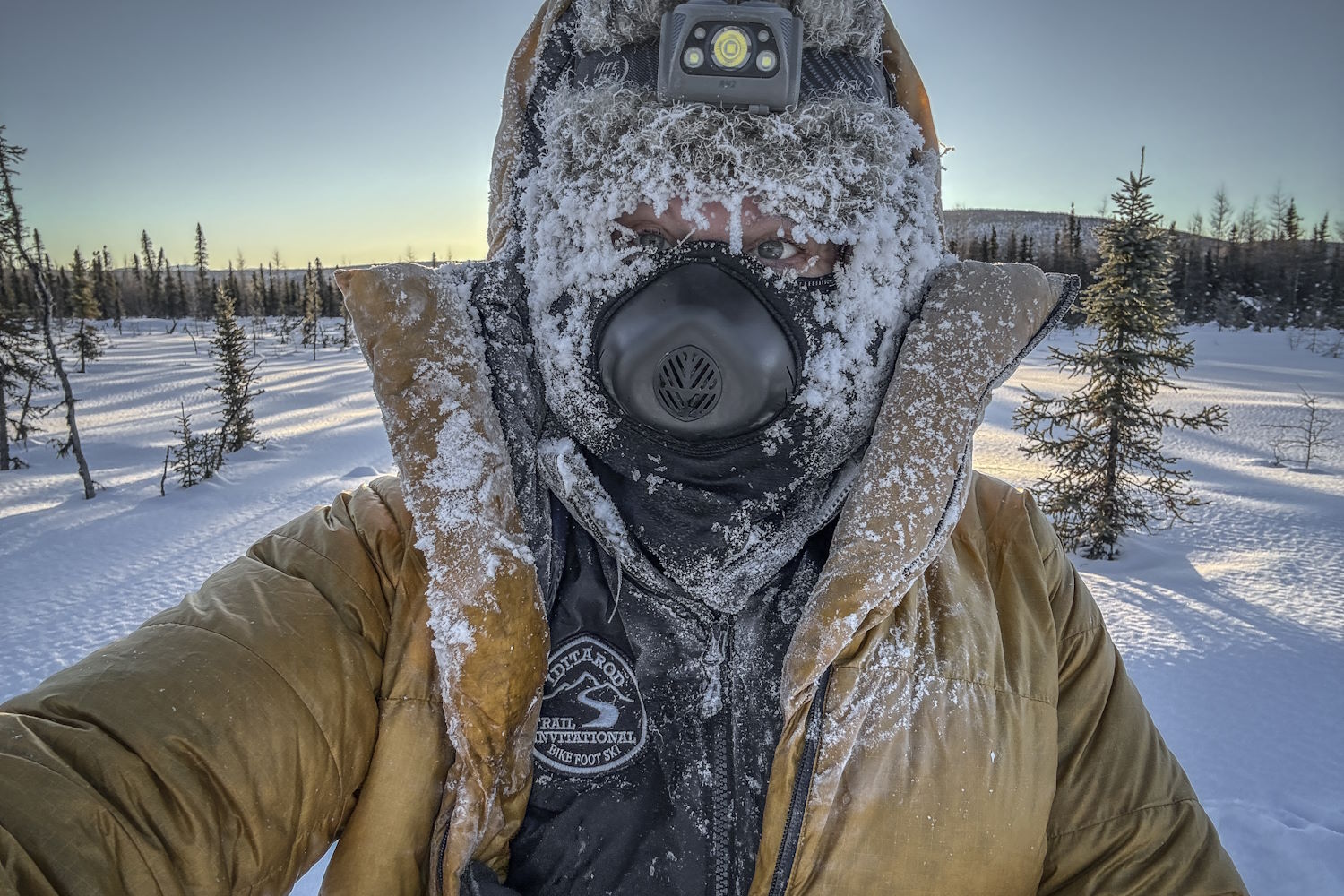 Sunny Stroeer on the Iditarod Trail, face and hood caked in frost at dawn