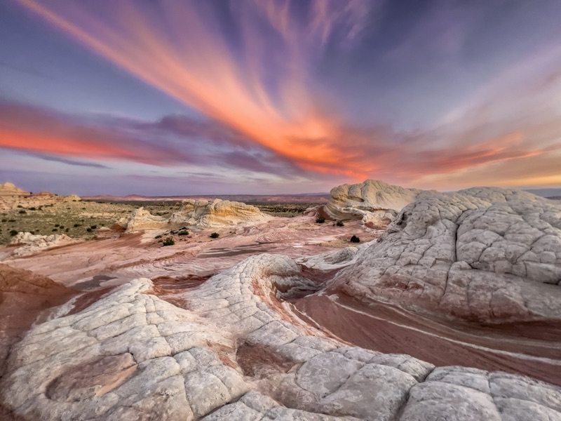 Sunset clouds streaking over the brain rocks of White Pocket, Arizona - aerial view